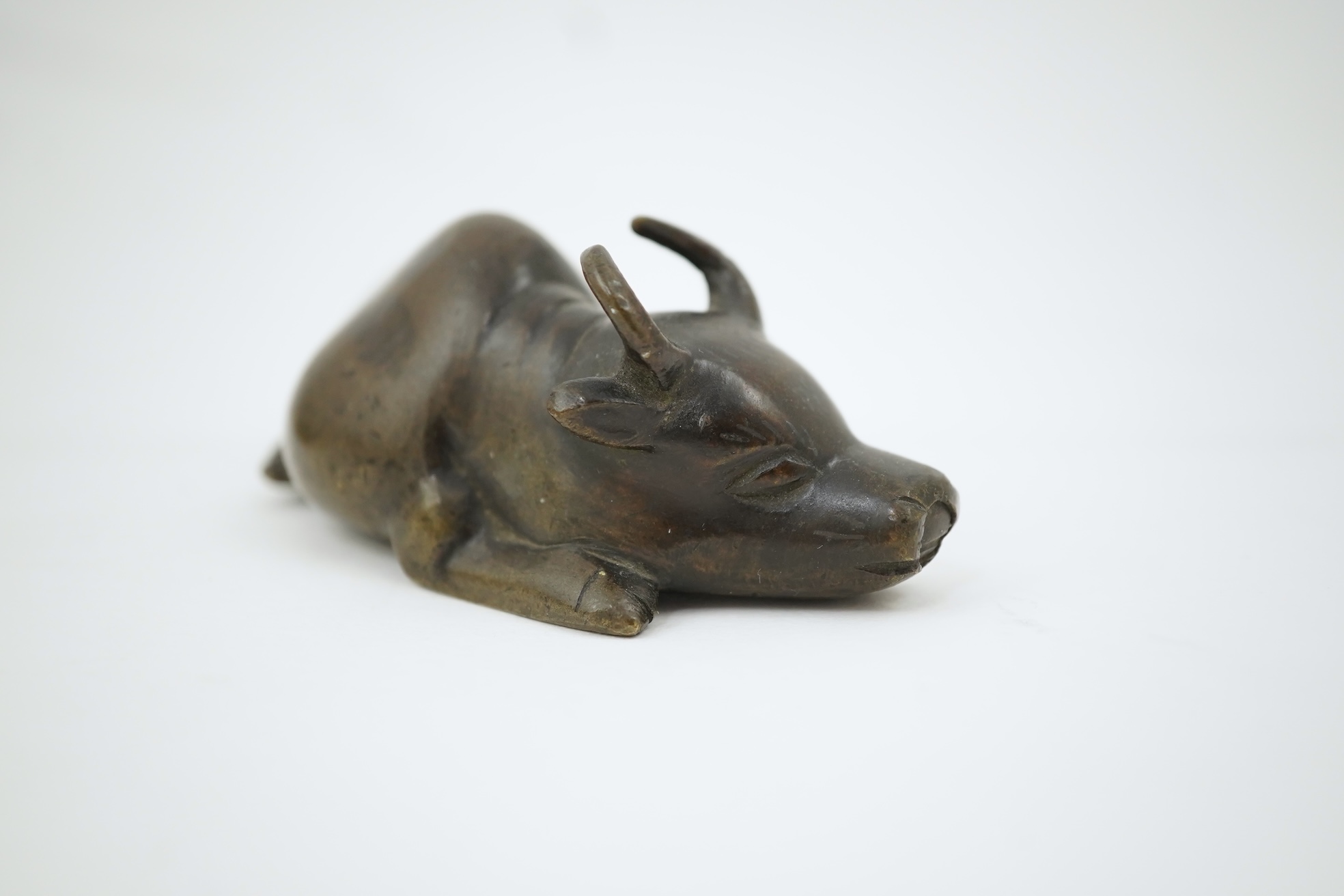 A Chinese bronze and mixed metal buffalo scroll weight, 19th century